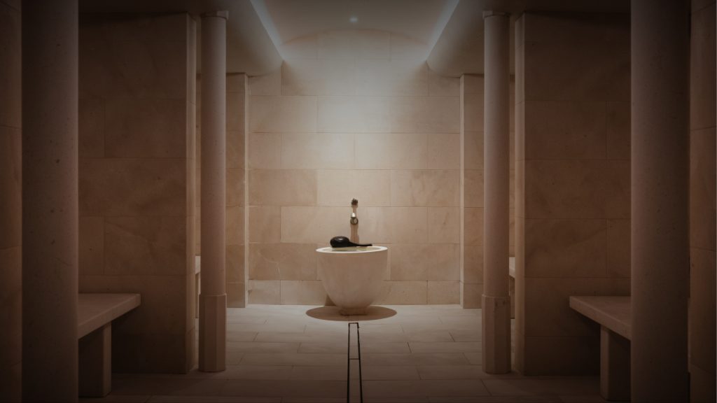 Bathroom interior with central sink and columns at Aman Le Mélézin