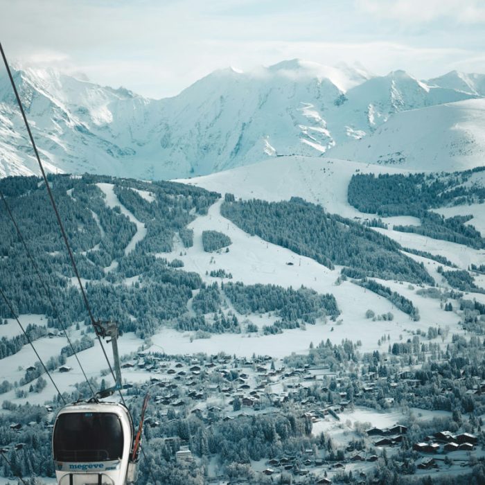 Snow-covered slopes and chalets of Megève seen from a cable car, French Alps