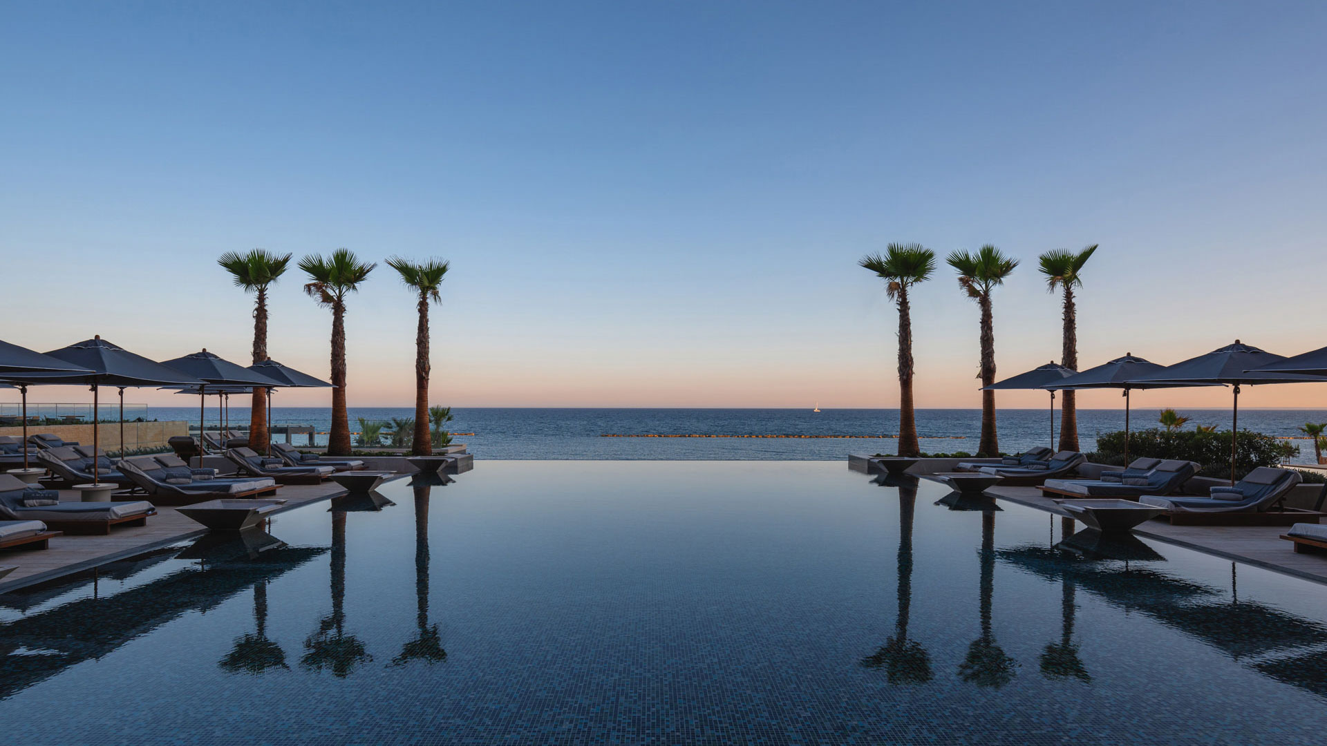 large pool with sunset on horizon