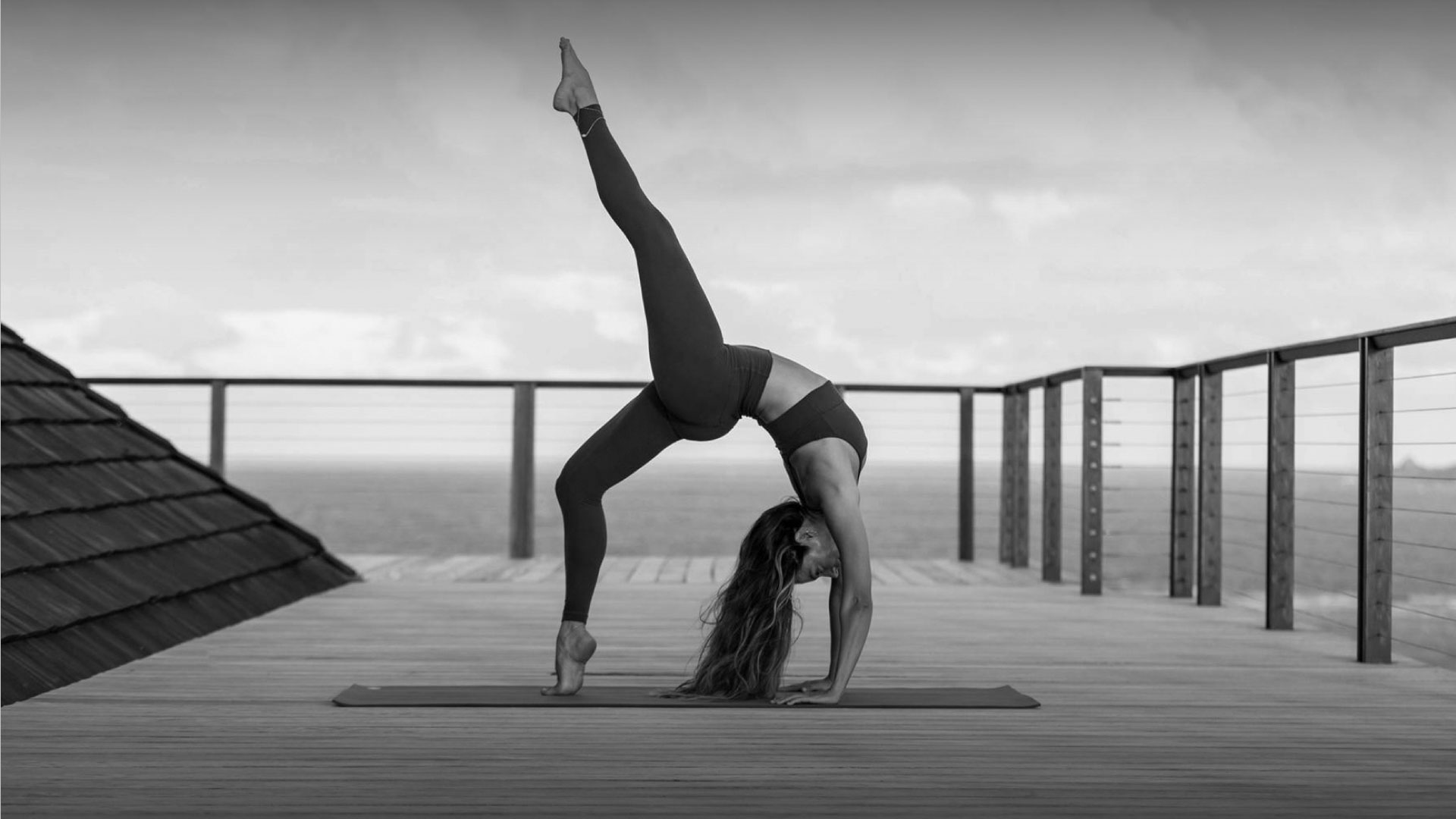 Woman practicing yoga on an ocean-view deck at Necker Island