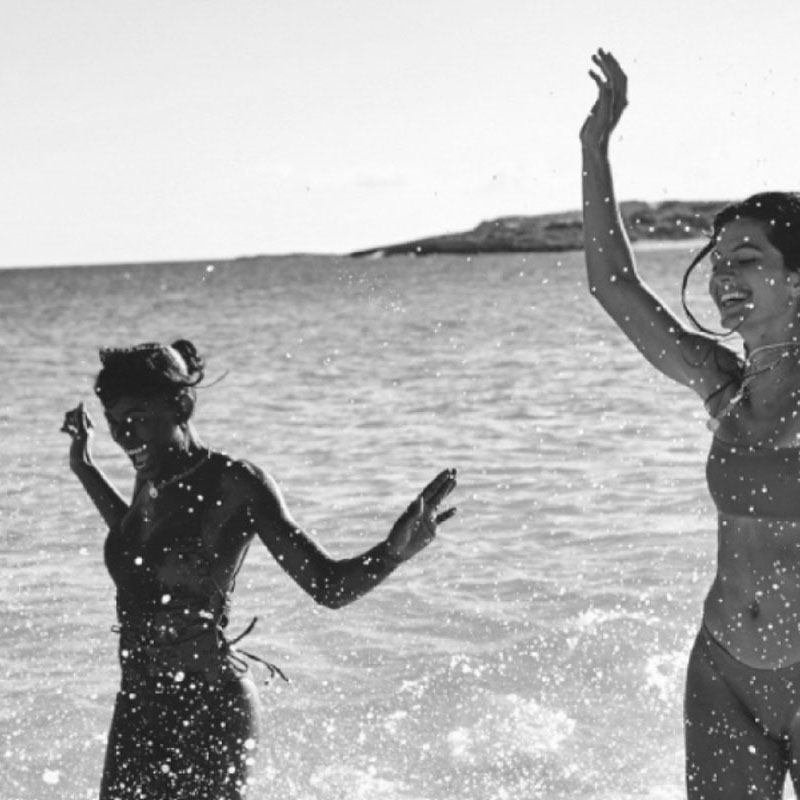 Guests splash and laugh in the shallow sea at Belmond Cap Juluca.