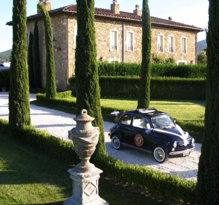 Stone farmhouse and cypress trees at Borgo Santo Pietro, Tuscany