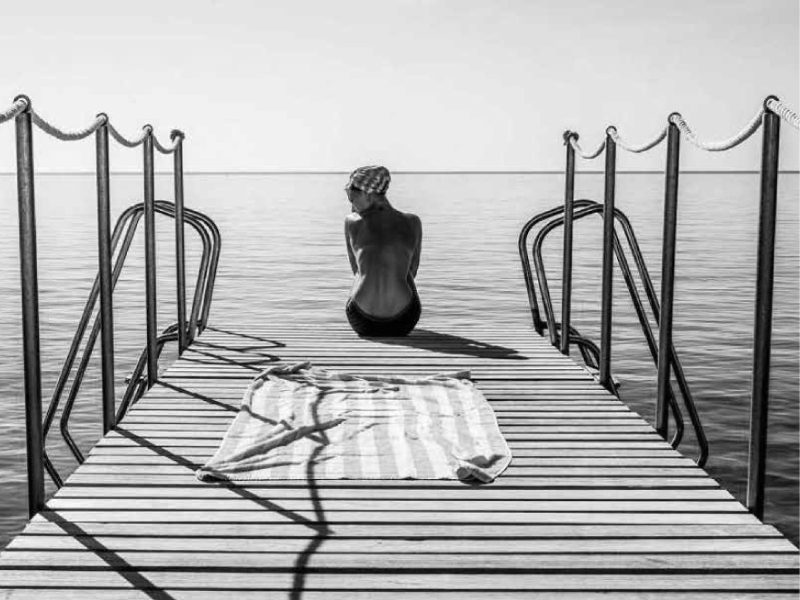 Swimmer sitting on the diving jetty at Hotel Il Pellicano, Porto Ercole