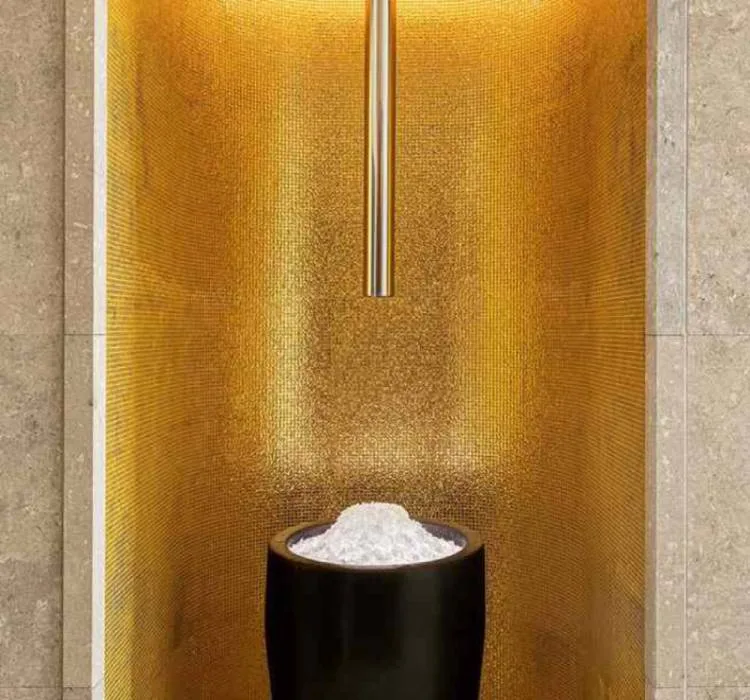 Gold mosaic wall and black stone basin in the spa at Bulgari Hotel Tokyo