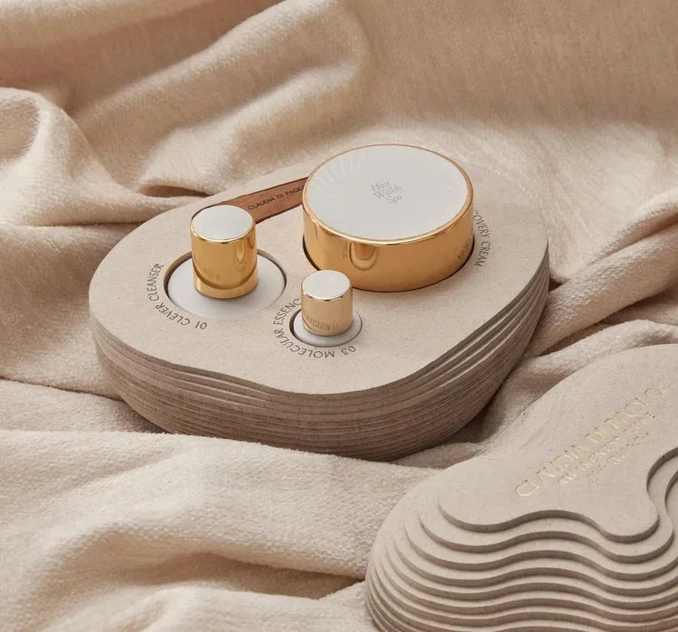 Gold-topped spa products on a shaped wooden tray at Rosewood Villa Magna