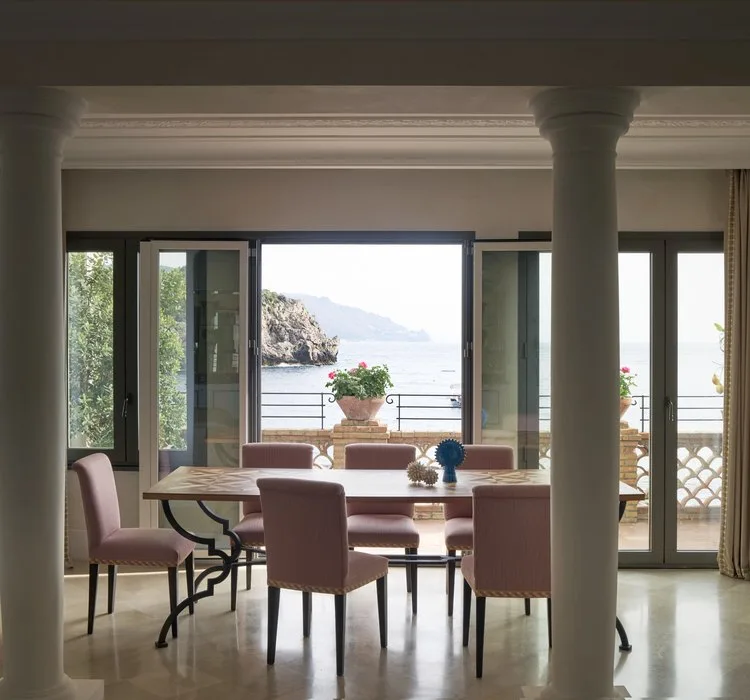 Suite dining room opening onto a sea-view terrace at Villa Sant'Andrea, A Belmond Hotel, Taormina Mare